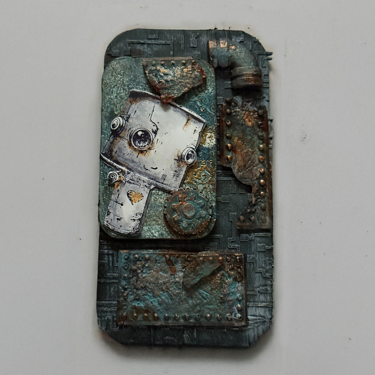 A decorative piece of art with a textured background in grey and a robot.