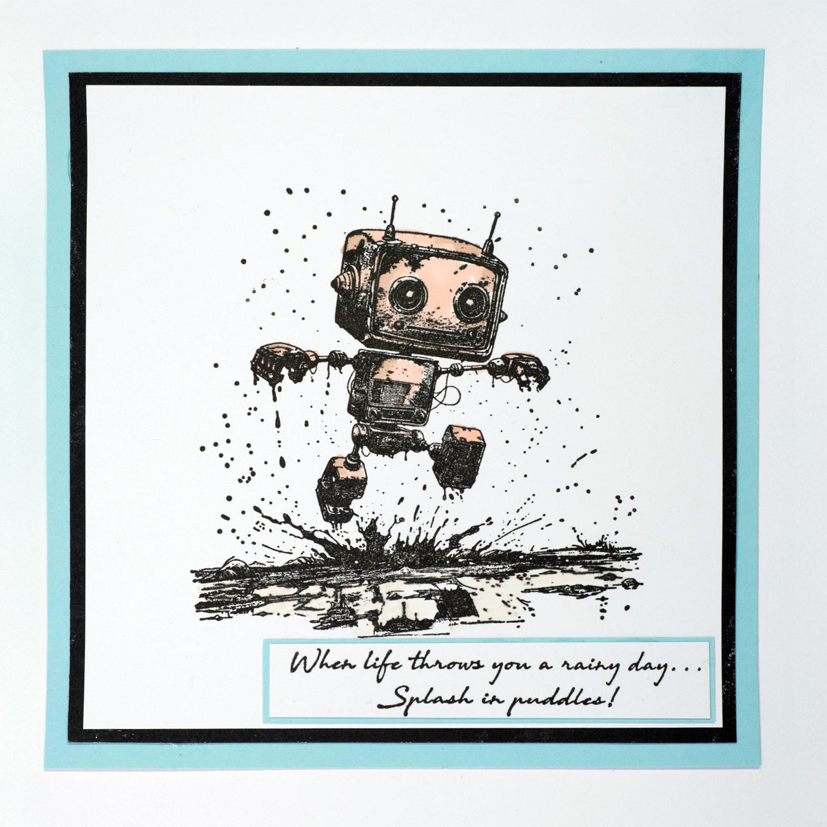 Illustration of a robot with the quote 'When life throws you a rainy day... splash in the puddles' on a light blue background