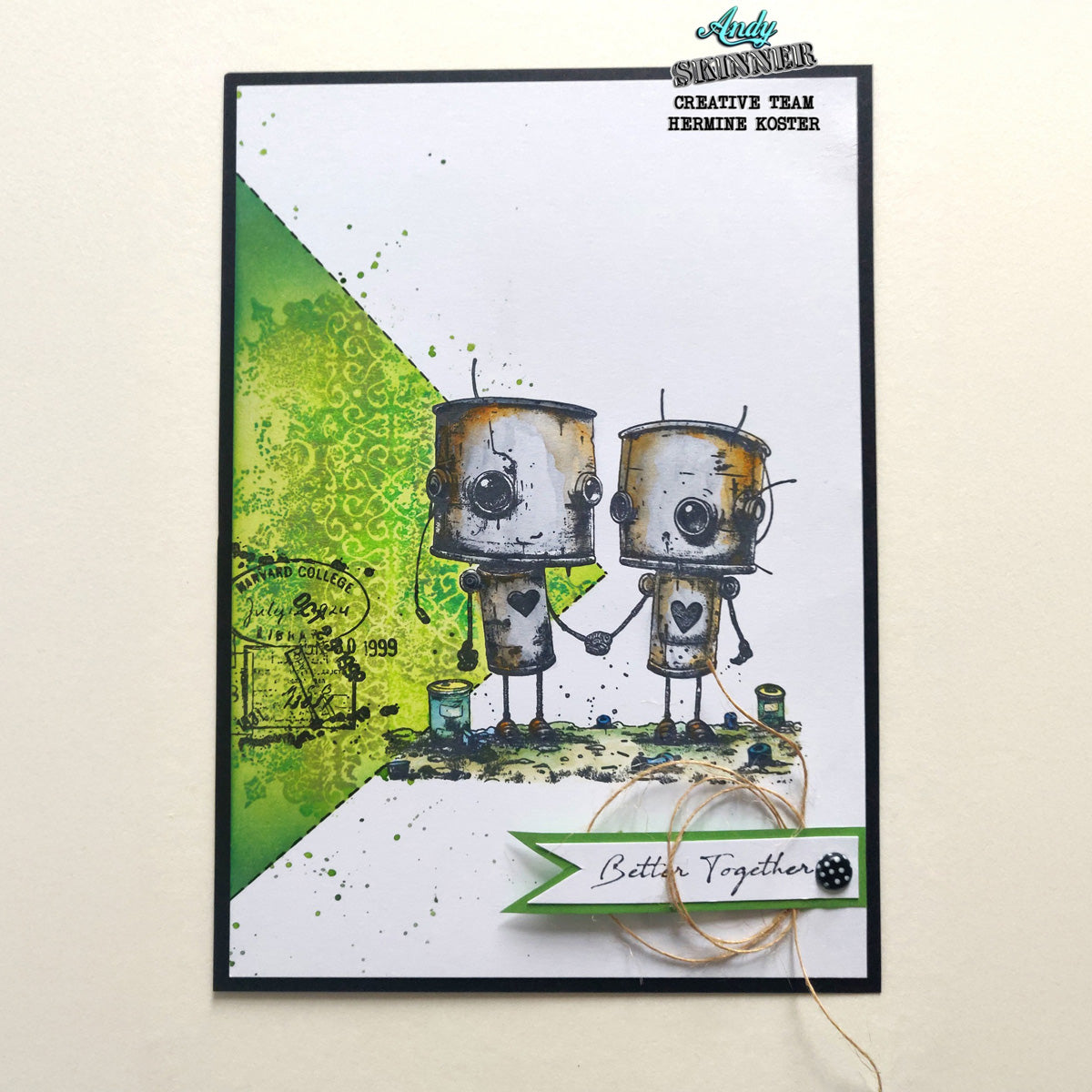 Card with two robot-themed stamps holding hands on a white background with green accents.