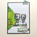 Card with two robot-themed stamps holding hands on a white background with green accents.