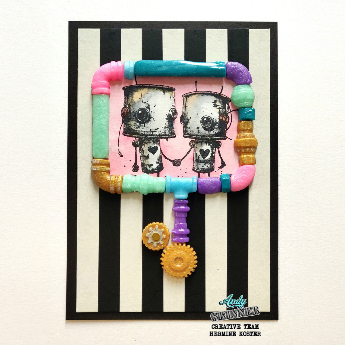 A card with two robots surrounded by a colourful pipes boarder with a black and white vertical stripe background.