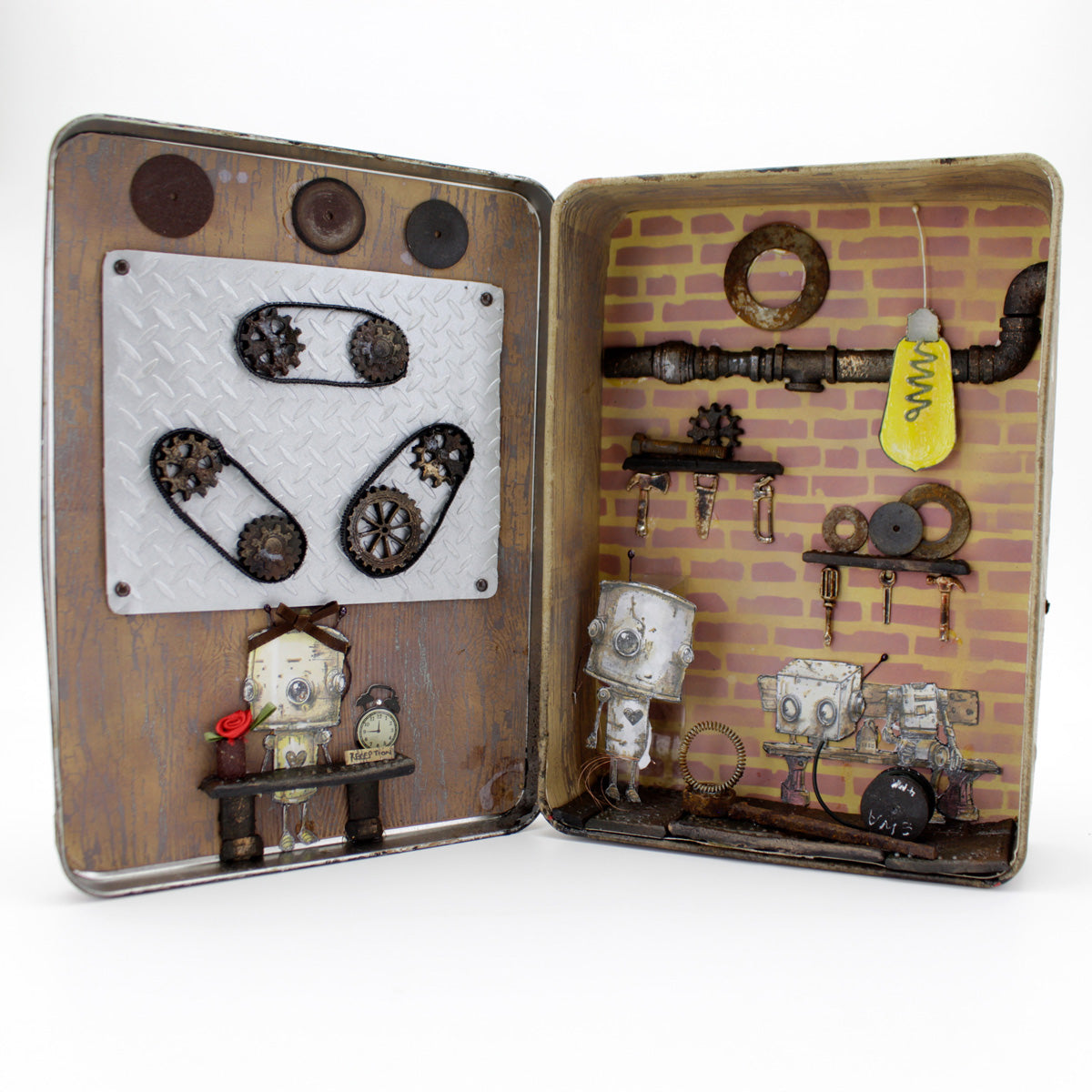 Open tin box with mechanical-themed such as pipes and cogs decorations with 3 robots on a white background