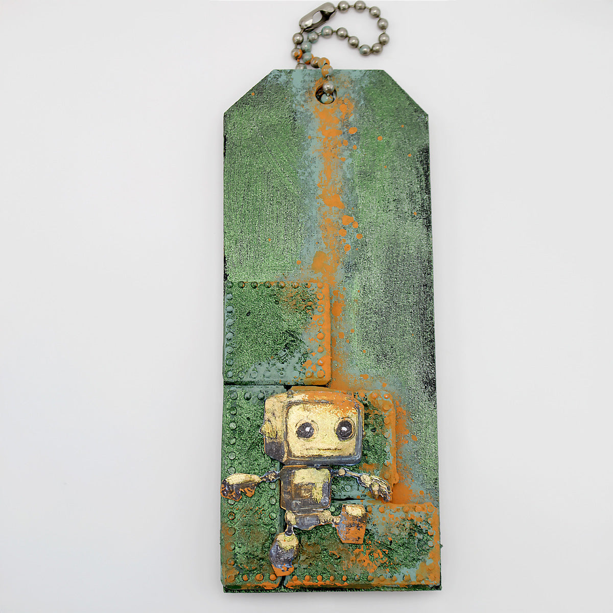 A green textured tag using the mould with a robot stamp.